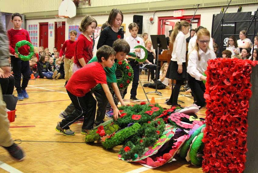 Colby (left) and Noah (right) Fievet, brothers both students at A.G. Baillie Elementary School in New Glasgow lay a wreath during the school’s Remembrance service that include music, poems and tributes to fallen soliders.