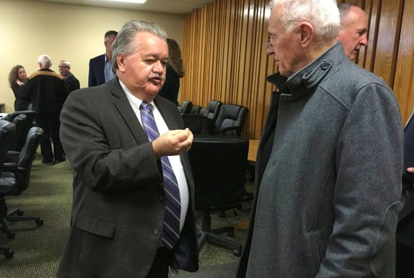 Minister of Natural Resources Lloyd Hines, speaks with former Premier John Hamm at a gathering Thursday at the Pictou County Chamber of Commerce.