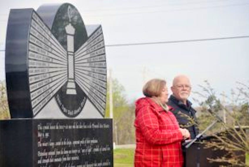 ["Allen and Debbie Martin read the names of miners who died, including Allen's brother Glenn. "]