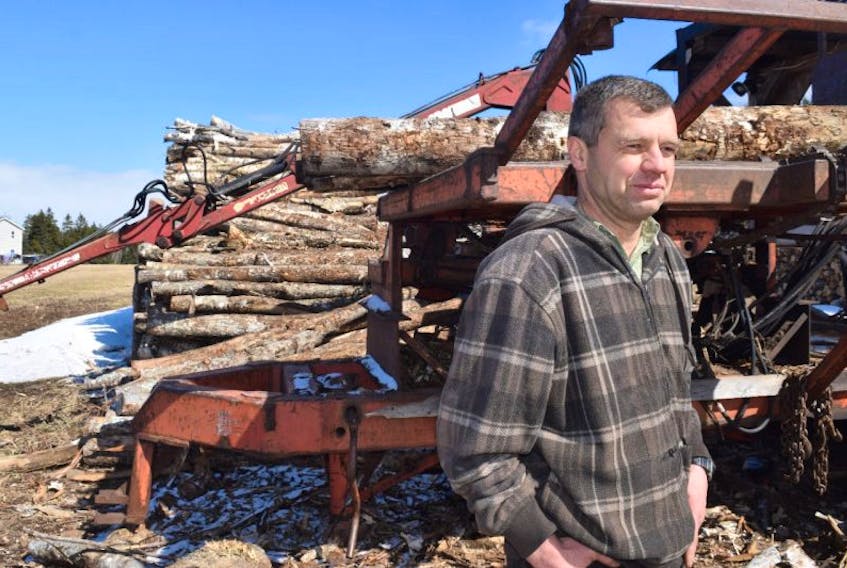 David Friesen stands in front of his wood splitter on Scotch Hill Road.