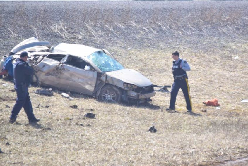 Police examine a car involved in a crash near Pleasant Valley Wednesday afternoon.