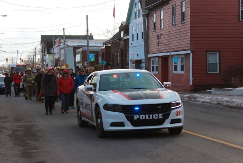Approximately 100 people walk through Stellarton Sunday in honour of Catherine Campbell, who was a member of the Stellarton Fire Department before her death in 2015.