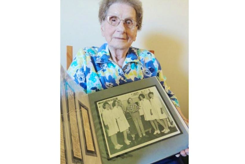 Dorothy Jardine looks over a scrapbook of press clippings from when her son Jimmy became a kidney transplant recipient almost 50 years ago. His was only the second transplant performed in Halifax. 