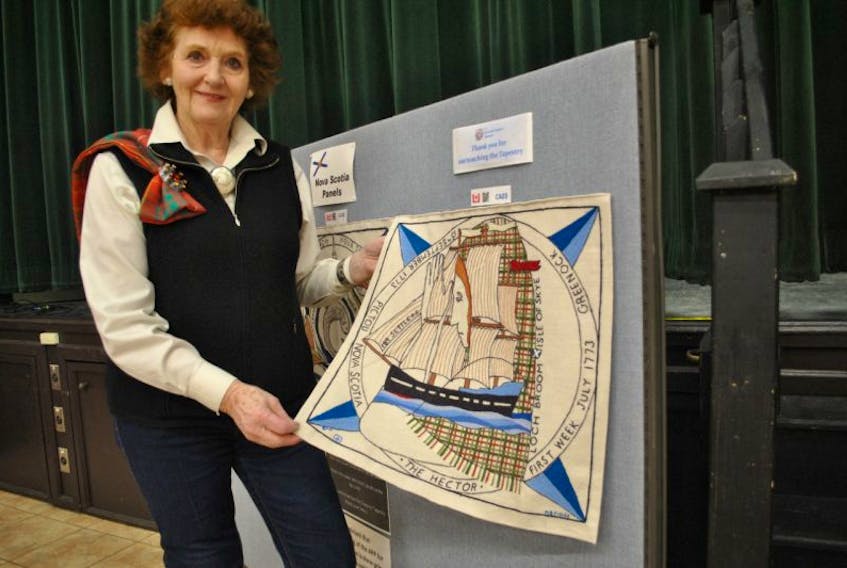 Tour director Jenny Bruce shows the embroidered panel depicting the Ship Hector at the Scottish Diaspora Tapestry Exhibition at Glasgow Square. The exhibit is being hosted locally by the St. Andrew’s Society of Pictou County and the Town of New Glasgow.