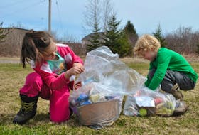 Scotsburn Elementary School students, including Georgia McNeill and James Ross, were out on Friday picking up litter around their schoolyard and nearby areas.