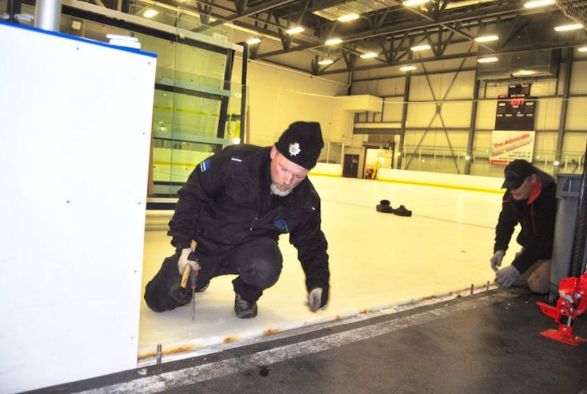 Jason Lynch (left), operations manager at the Pictou County Wellness Centre, transforms the ice surfaces on Wednesday into a show room for an event planned for this weekend. 