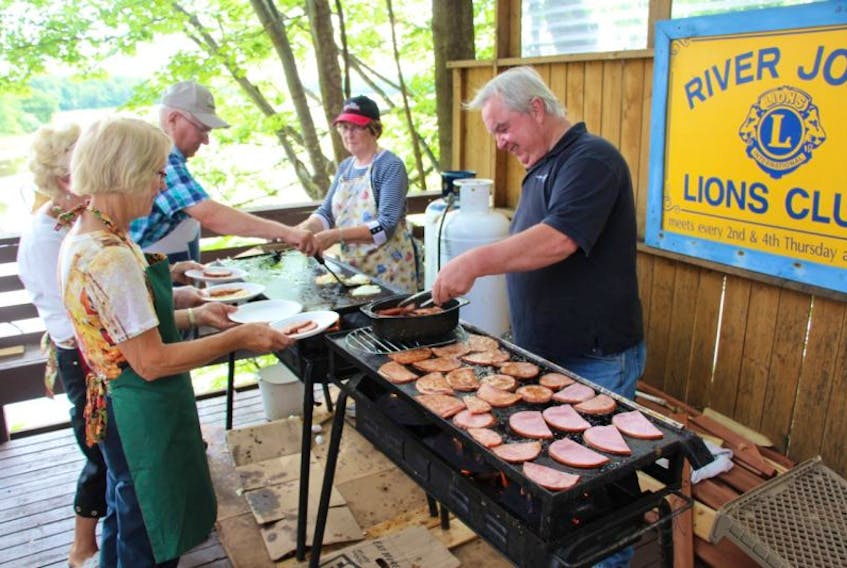 Members of the local Rehekah and IOOF were serving up breakfast in River John Thursday as part of The River John Festival Days.  Here, Marie Langille, back, left, and Dan Ferguson, back, right, fry up eggs and ham for servers, Ronnie Langille, front, left, Margaret Langille and Agnes Murray.