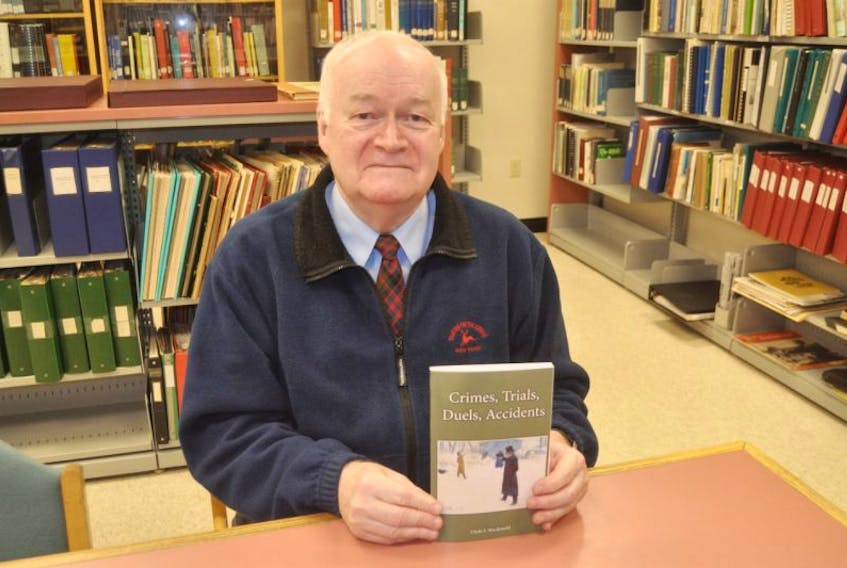 Clyde Macdonald holds a copy of his book, “Crimes, Trials, Duels, Accidents.” This is the 13th book he’s written.