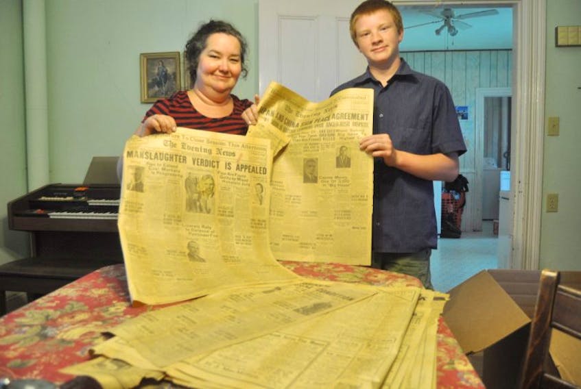 Angela Hanebury and her son Anthony found old copies of The Evening News and The Chronicle Herald underneath flooring in their home. 