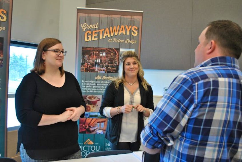 Allison Hartson and Ashdenne Pitts of Pictou Lodge speak with job seeker David MacKinnon at a job fair hosted by Career Connections Nova Scotia Works Pictou County
on Wednesday. 
