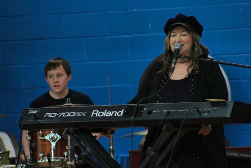 Grade 8 student James Swallow, left, joined Doris Mason on stage as part of Blues in the School, a program brought to local elementary schools by the Pictou County Blues Society. 