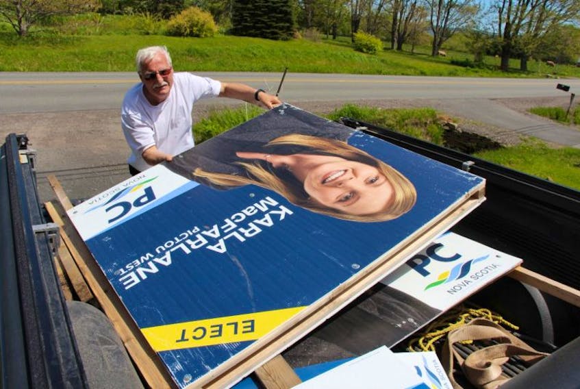 Frank MacFarlane collects his daughter Karla’s election signs following the provincial election Tuesday.  Karla reclaimed the seat for Pictou West for the Progressive Conservative Party.  She will be joined by fellow PC MLAs Tim Houston of Pictou East and Pat Dunn of Pictou Centre. 