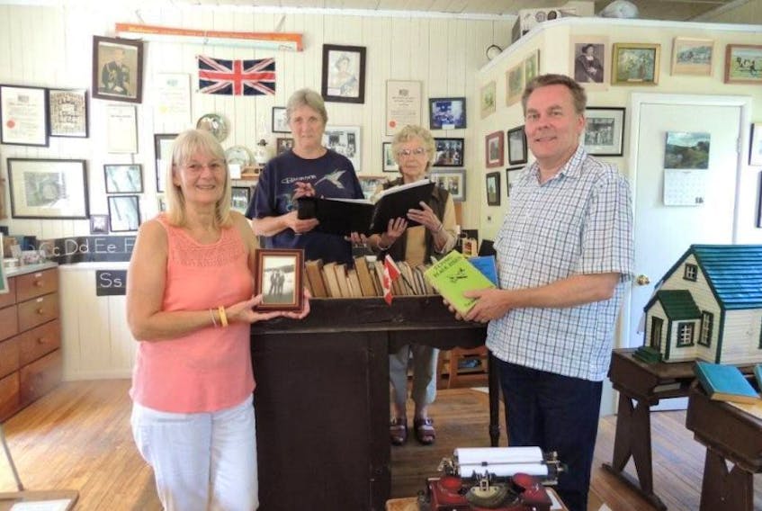 English visitors Lynne and Mark Purkiss, in foreground, travelled to Barneys River Schoolhouse Museum where Rosanne Bland of Mount Uniacke and Nova Bannerman helped pieced together wartime evacuee Ronald Mizon’s years in Nova Scotia.