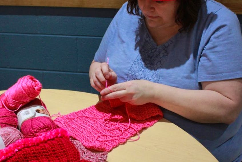 Donna MacGregor is shown making a “pussy hat,” a project taking place worldwide for participants to wear during the Women’s March on Washington and local events.