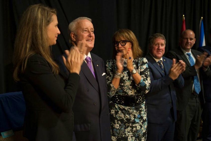 Brian Mulroney is applauded by his daughter Caroline and wife Dr. Mila Mulroney after his speech during sod turning for the Brian Mulroney Institute of Government and Mulroney Hall building at StFX Wednesday. 