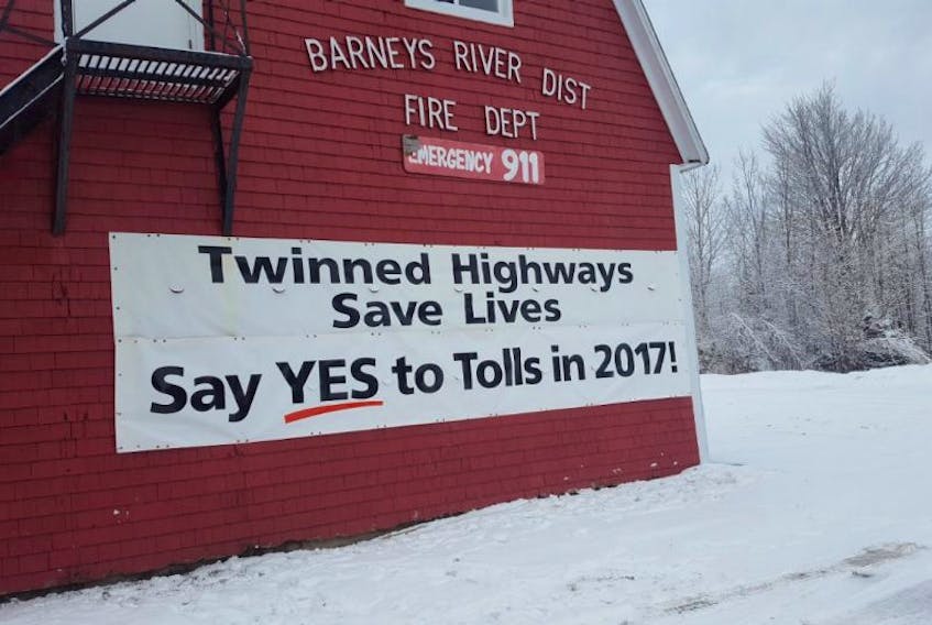 A banner hangs on the Barney's River Fire Department encouraging people to support twinning the Hwy 104 through to Antigonish.