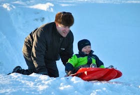 Preston Burns and two-year-old Dawson of New Glasgow enjoyed the sledding hill at the Albion Ball Field on a sunny day last week. Coasting will be one of the activities offered by the Town of Stellarton as part of its Family Fun Day on Monday.