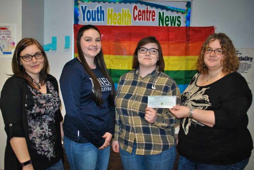 Vania MacMillan, executive director of the Pictou County Centre for Sexual Health, shown at right, presents a cheque to members of the Gender Sexuality Alliance at North Nova Education Centre, a donation for their fundraising efforts to offer a bursary to graduating students. Teacher adviser Jenn Giles and co-chairpersons Victoria Robertson and Jessica Campbell are shown accepting the donation.
