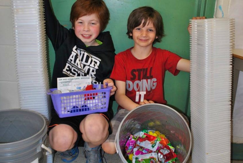 Noah Fievet and Sam Wagner, students at A.G. Baillie Memorial School, show the recyclables collected by the school that will be turned into new products, while also raising money for the school.
