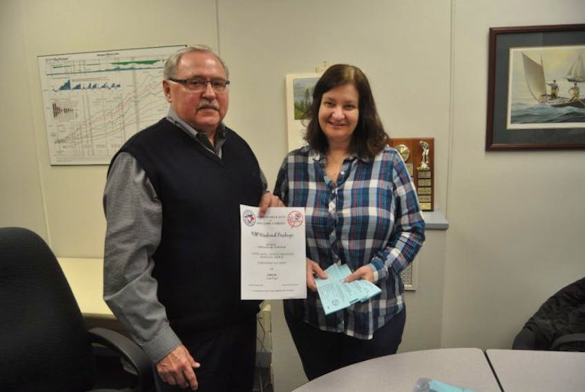 Darlene Taylor and Russ Oehmen hold tickets for an upcoming draw to a Blue Jays game. They are selling the tickets as a fundraiser for repairs at Our Lady of Lourdes.
