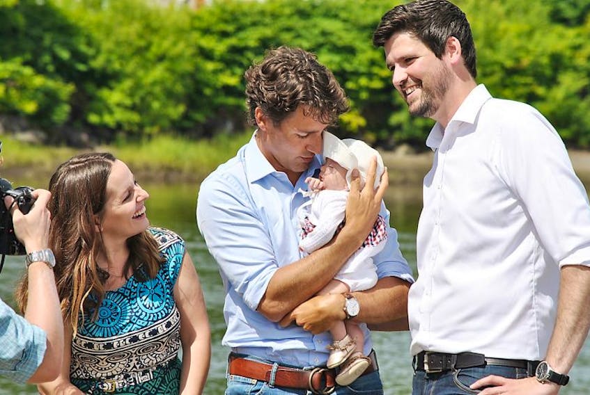 Prime Minister Justin Trudeau holds Central Nova MP Sean Fraser’s infant daughter Molly during a barbeque hosted by Fraser on Aug. 16 in New Glasgow. Also shown are Fraser, right, and his wife Sarah Burton, left.