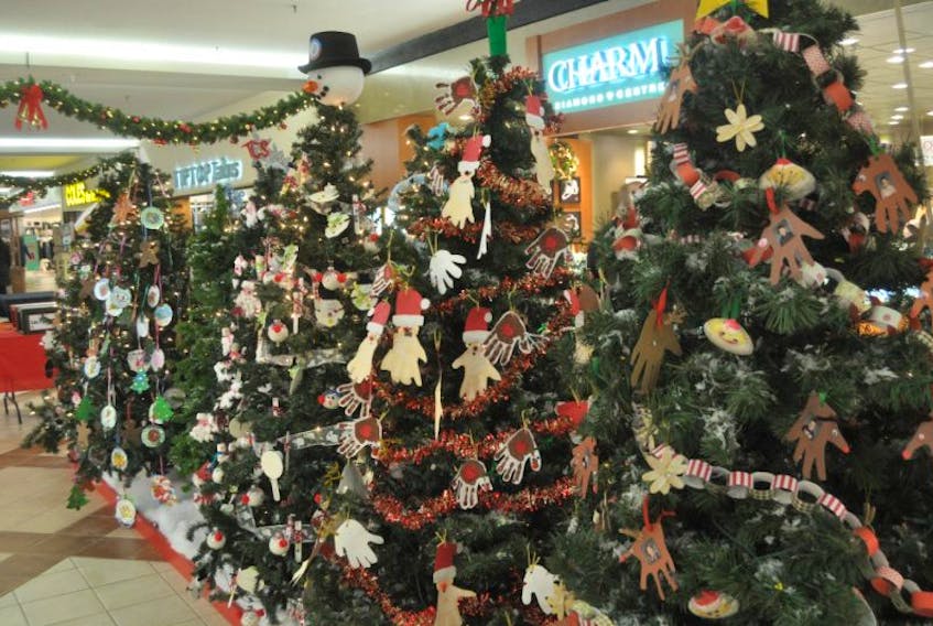 Christmas trees with ornaments by local elementary students are located in the Highland Square Mall.