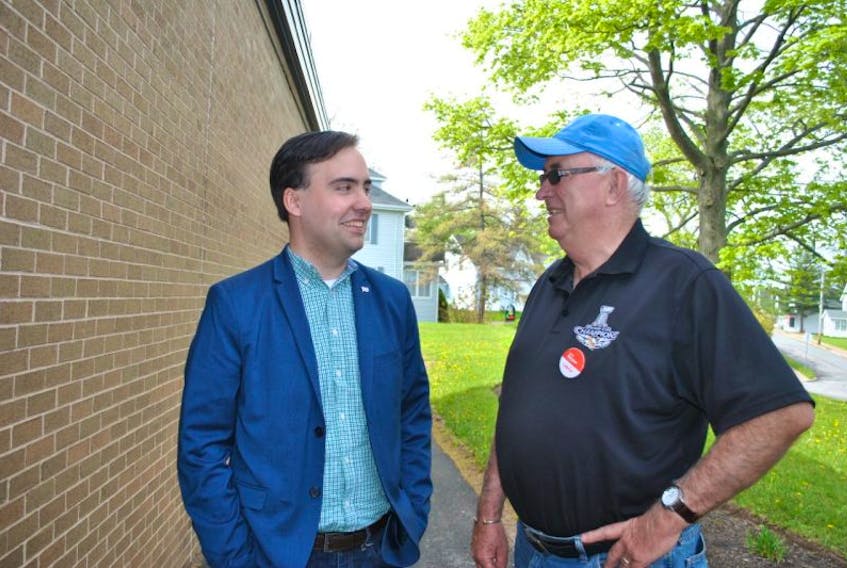 Pictou West Liberal candidate Ben MacLean chats with supporter James Clark.