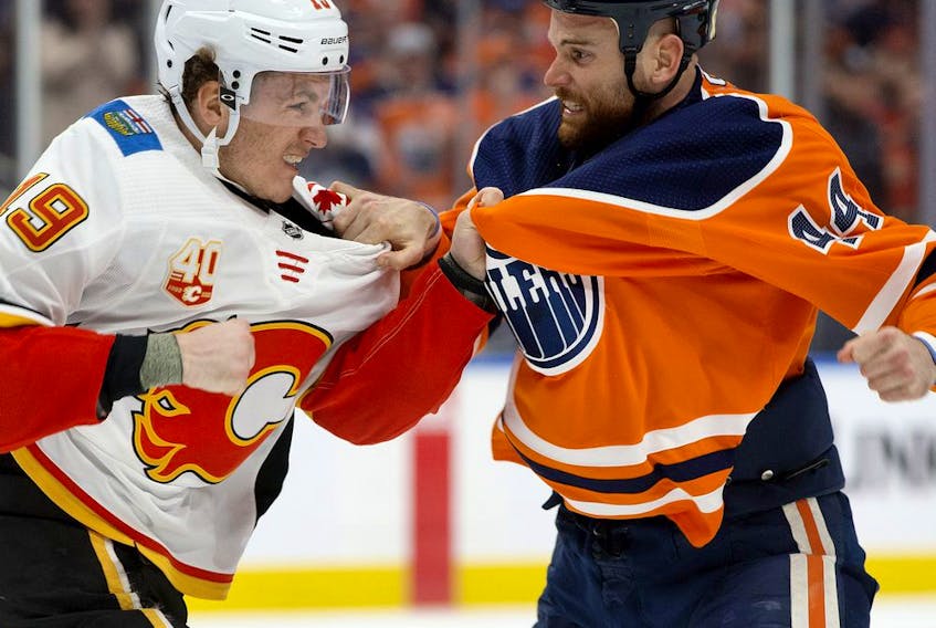 The Edmonton Oilers' Zack Kassian (44) fights the Calgary Flames' Matthew Tkachuk (19) during first period NHL action at Rogers Place, in Edmonton Wednesday Jan. 29, 2020. 