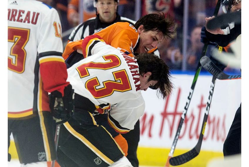 The Edmonton Oilers' Ryan Nugent-Hopkins (93) fights the Calgary Flames' Sean Monahan (23) during first period NHL action at Rogers Place, in Edmonton Wednesday Jan. 29, 2020. Photo by David Bloom