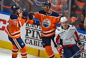 Edmonton Oilers’ defenceman Darnell Nurse, centre, celebrates his goal against the Washington Capitals with teammate Connor McDavid during NHL regular season action in Edmonton.