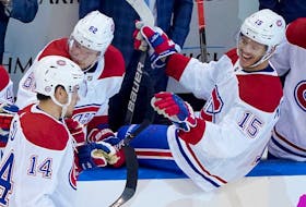 Montreal Canadiens’ rookie Nick Suzuki, left, is congratulated by teammate Jesperi Kotkaniemi, right, after Suzuki scored a goal in the second period against the Pittsburgh Penguins during Game 1 of the Eastern Conference qualification round Saturday in Toronto.