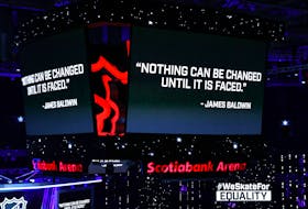 A quote by James Baldwin is displayed on the scoreboard at Scotiabank Arena in Toronto on Saturday. Sports leagues around North America are taking a stand against social injustice. Elsa/Getty Images
