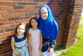 Nicole Mosher, shown with her two daughters aged seven and five, says the government should provide more clarity regarding who to contact and how to deal with a potential COVID-19 exposure