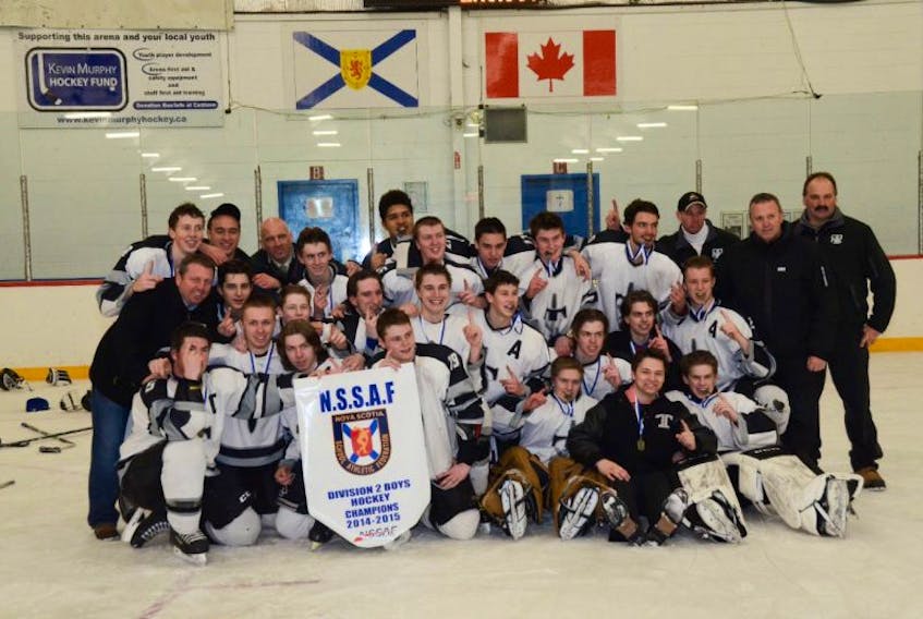 The NKEC Titans pose with the provincial championship banner after winning the fifth D-2 boys’ hockey championship in the school’s 14-year history March 27 on the Eastern Shore. NKEC has been provincial runner-up on three other occasions.