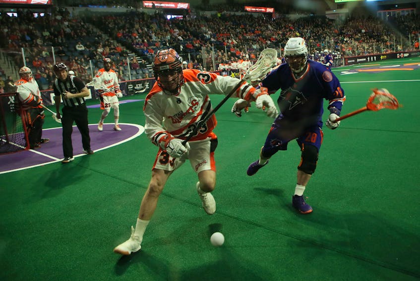 Jon Harnett of the Buffalo Bandits and Stephen Keough of the Halifax Thunderbirds chase down a loose ball during National Lacrosse League action March 8 at Scotiabank Centre. TIM KROCHAK / The Chronicle Herald 