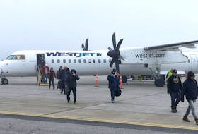 Passengers disembark from a WestJet Encore plane at the JA Douglas McCurdy Sydney Airport Thursday. There are no flights at all from any airlines at the airport Friday. CONTRIBUTED