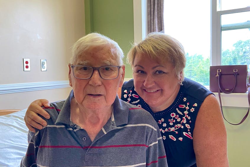 Shelley Esposto of Paradise visits her father, Augustus, in person Monday at the Corner Brook Long-term Care Centre for the first time since December 2019. New visiting rules came into effect Monday that allow up to six designated visitors to take turns visiting loved ones in long-term and personal care homes in the province.