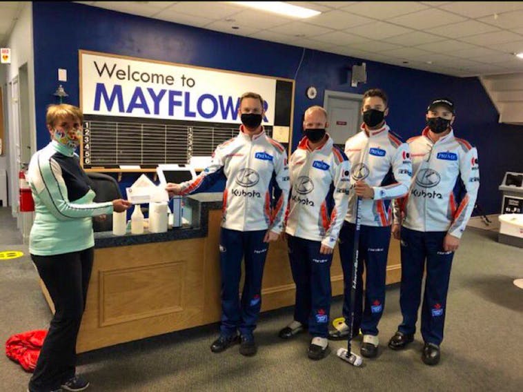 These masked men came away with the money Sunday in Halifax. Brad Gushue’s team from the Remax Centre (St. John’s Curling Club) won the Dave Jones Stanhope Simpson Insurance Cashspiel over the weekend at the Mayflower club. Gushue and teammates Mark Nichols, Brett Gallant and Joel Krats are shown accepting the $4,000 first-place prize. — Submitted photo

