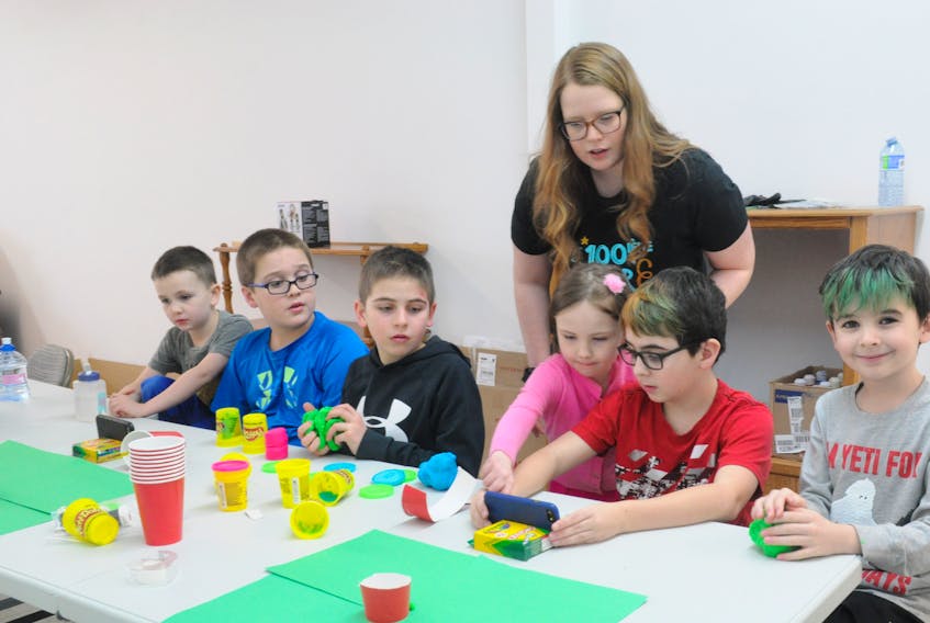 Participants of Nomad Stages science technology, engineering, art and math (STEAM) class learn how to create a volcano under the instruction of Stacey Carter, back. Participants include, from left, Donny Flynn, Jayden Fry, Ryden Lucas, Claire Loretta Flynn, Noah Davis-Peddle and Maddix Davis-Peddle. FRANK GALE/THE WESTERN STAR