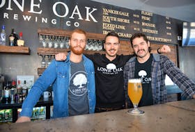 Dillon Wight, left, Jarod Murphy and Spencer Gallant, right, co-owners of Lone Oak Brewing Co. in Borden-Carleton, stand behind the bar in the brewery's taproom. The business had its official grand opening on Jan. 25.
TERRENCE MCEACHERN/THE GUARDIAN