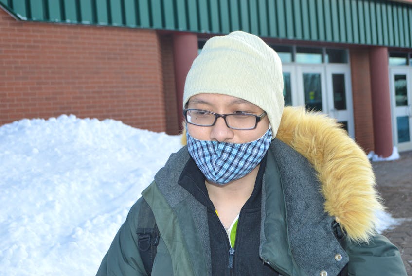 Vo Phuc, originally of China, currently living in Sydney and attending Cape Breton University, heads to class on the campus Tuesday. Phuc said he wears a surgical mask to keep his face warm but also becasue he believes it protects from viruses, The masks are getting harder to find as Chinese people in Cape Breton say they are desperately searching for them to mail home to family in China, where due to the outbreak of the coronavirus, the masks can’t be found right now. Sharon Montgomery-Dupe/Cape Breton Post