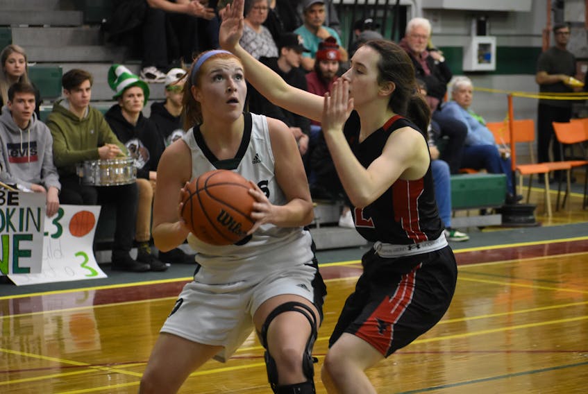 Avery McKinnon of the Breton Education Centre Bears, left, looks to shoot as she's watched by Maddie Long of the Northumberland Nighthawks during New Waterford Coal Bowl Classic action at the BEC gym last February. - Jeremy Fraser