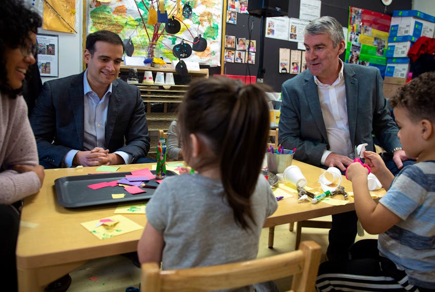 Education Minister Zach Churchill and Premier Stephen McNeil talk with students and staff prior to a pre-primary nnouncement at Chebucto Heights Elementary earlier this month. An expert in work sociology says these kinds of programs can help boost family incomes. - File