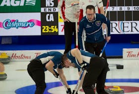 Nova Scotia skip Scott McDonald  watches as Phil Crowell and Scott Saccary sweep a rock into the house during action against Team Canada at the Tim Hortons Brier on Tuesday. Canada skip Brad Gushue and third Mark Nichols look on. Michael Burns / Curling Canada