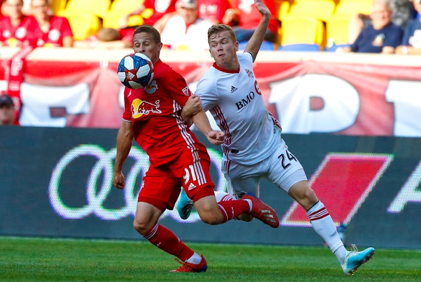 Toronto FC midfielder Jacob Shaffelburg, right, battles New York Red Bulls defender Race Buckmaster during a 2019 MLS game at Red Bull Arena in Harrison, N.J. (Noah K. Murray-USA TODAY Sports)
