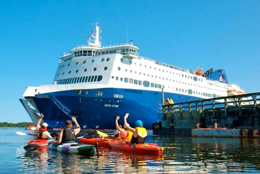 a group of kayakers waves to those aboard the Nova Star as the ferry departs Yarmouth.<br />CARLA ALLEN PHOTO