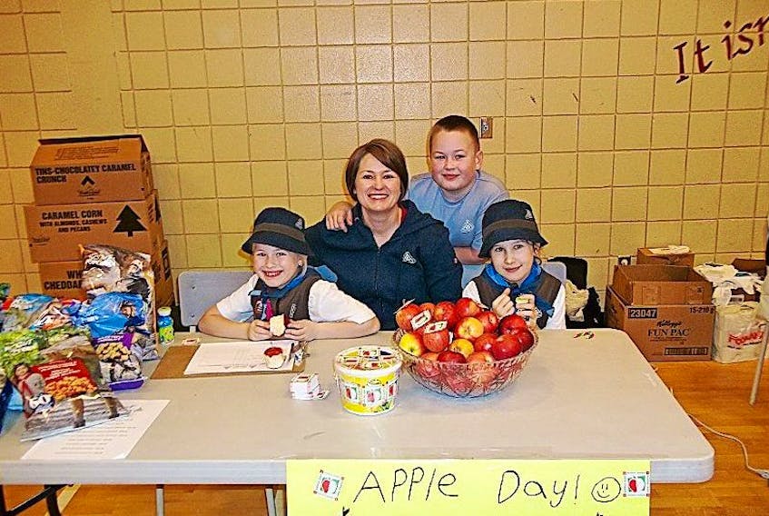 Leana Wiltshire, Bev Wiltshire, Neal Whiltshire and Lauren Beers set up for Apple Day at the French Shore Academy in Port Saunders on Saturday, Nov. 28.