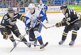 In this 2016 file photo, Nathan Noel of the Saint John Sea Dogs skates between Cape Breton Screaming Eagles defencemen Jonathan Deschamps and Duncan MacIntyre (right) during Quebec Major Hockey League action at Harbour Station in Saint John, N.B. 