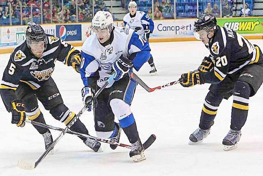 In this 2016 file photo, Nathan Noel of the Saint John Sea Dogs skates between Cape Breton Screaming Eagles defencemen Jonathan Deschamps and Duncan MacIntyre (right) during Quebec Major Hockey League action at Harbour Station in Saint John, N.B. 