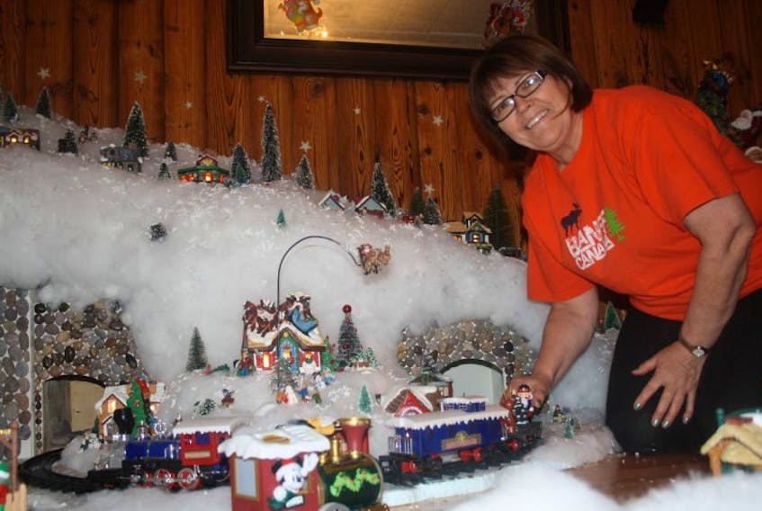Deborah Barney sets to work on one of the trains as she builds up her Christmas village on December 13.